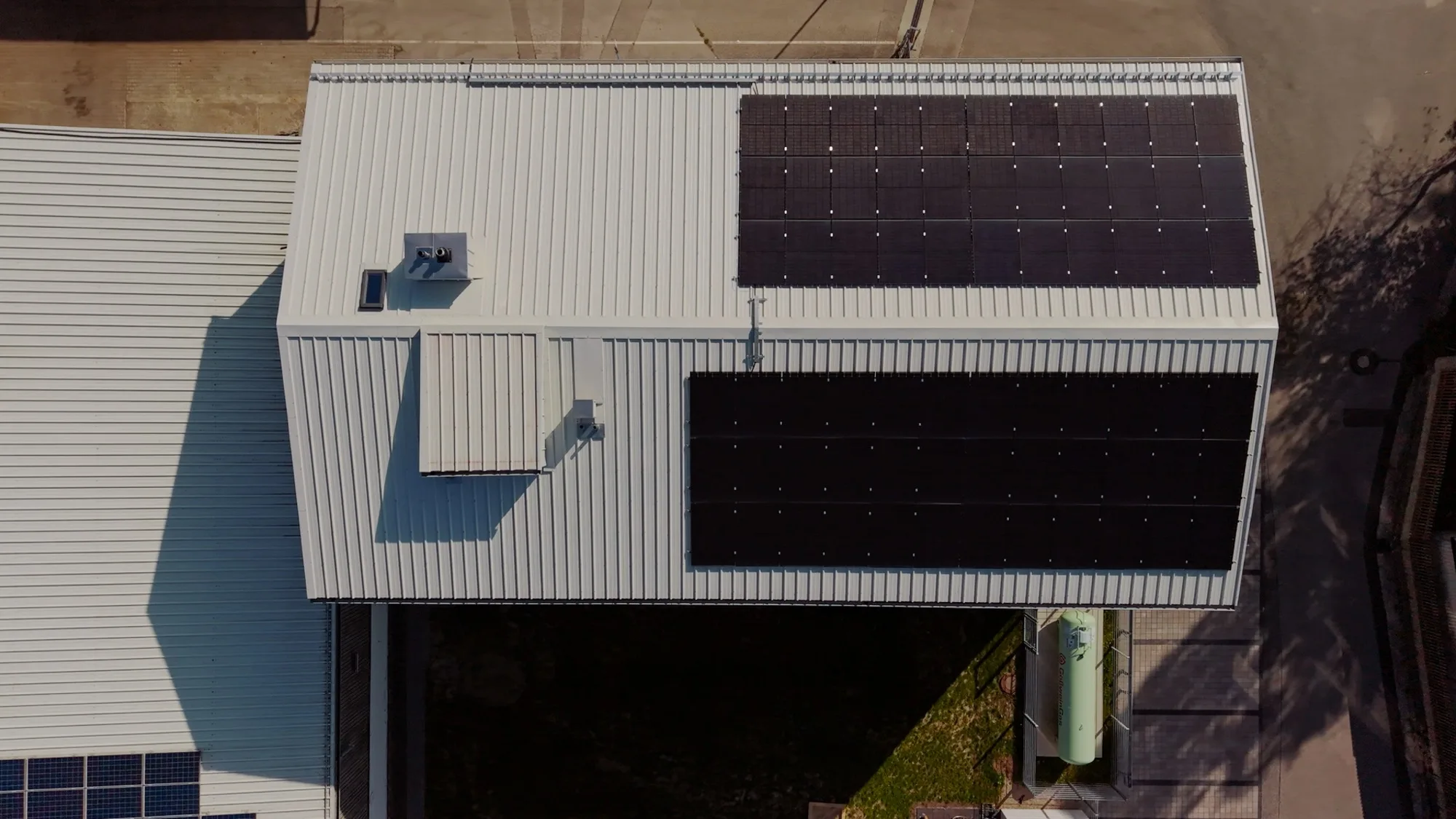 Senkrechte Aufnahme eines Hallendachs mit zwei Photovoltaikfeldern